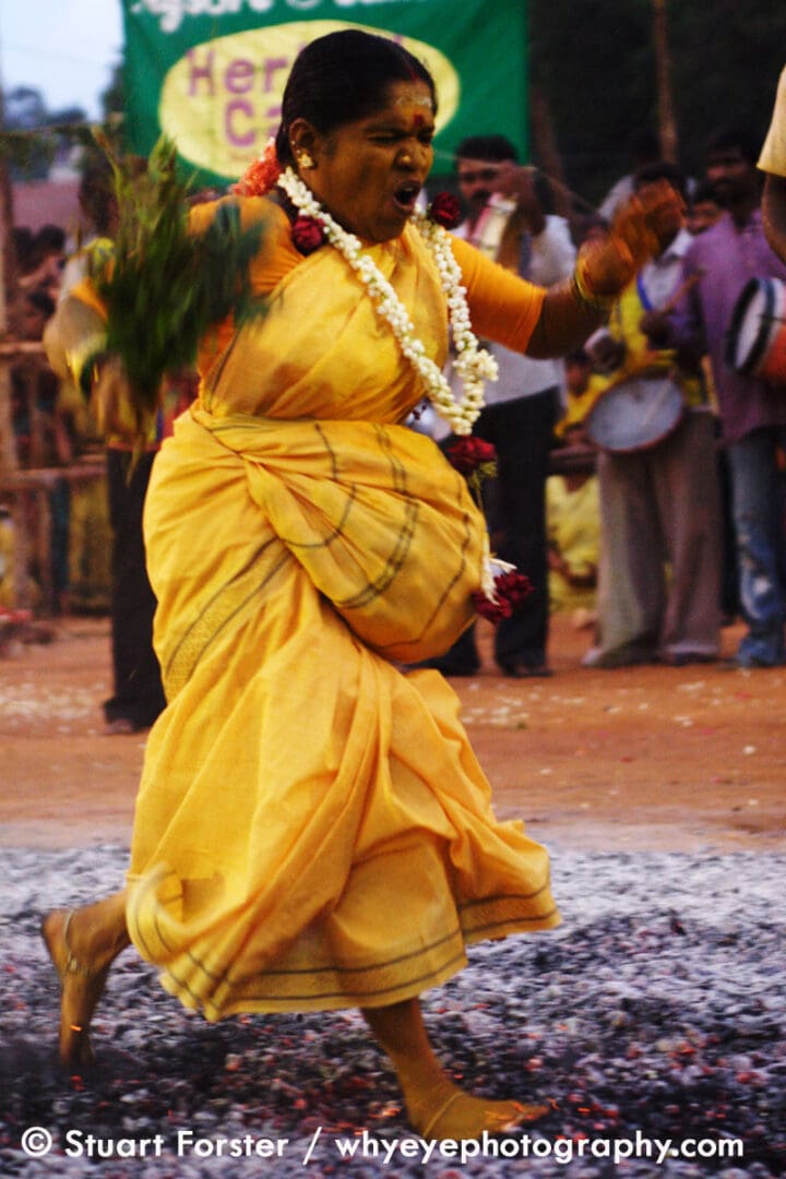 Woman walking on hot ash during the Sri Drowpathy Amman Firewalking Festival in Bengaluru (Bangalore), India