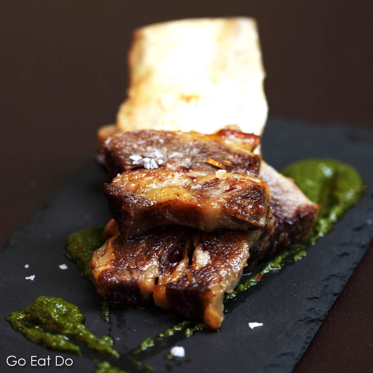 Slow-cooked short ribs served with green mojo sauce at Ibérica La Terraza, a Spanish restaurant at Canary Wharf, London.