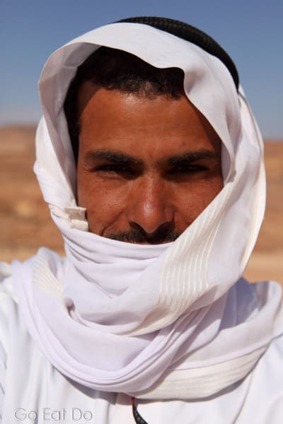 Selmi, a Bedouin guide in Egypt, wearing a keffiyeh, traditional Arabic clothing