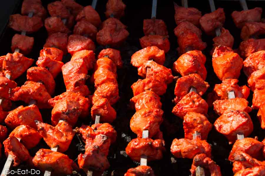Chicken being grilled over a charcoal grill at the Newcastle Mela in Newcastle-upon-Tyne.