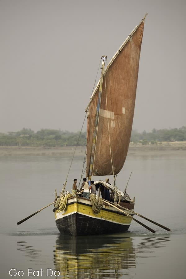 A boat sailing on water in the Sundarbans National Park on the border of India and Bangladesh.
