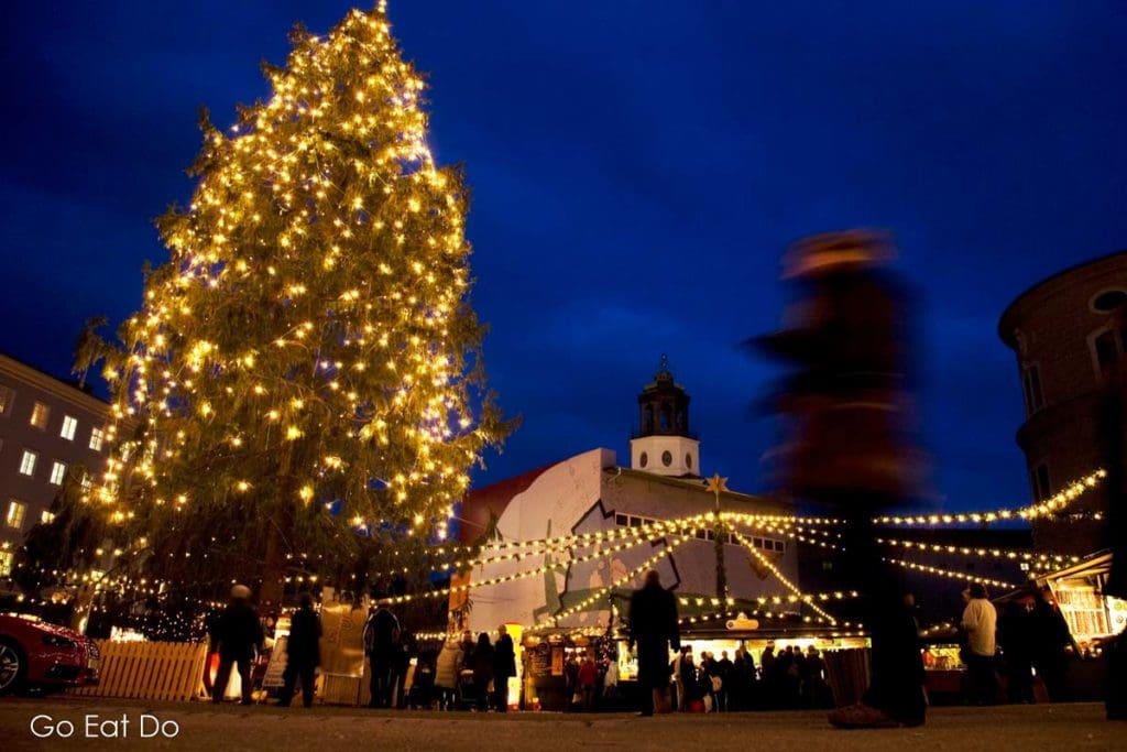 A Christmas tree illuminated as night falls on the Salzburger Christkindlmarkt.