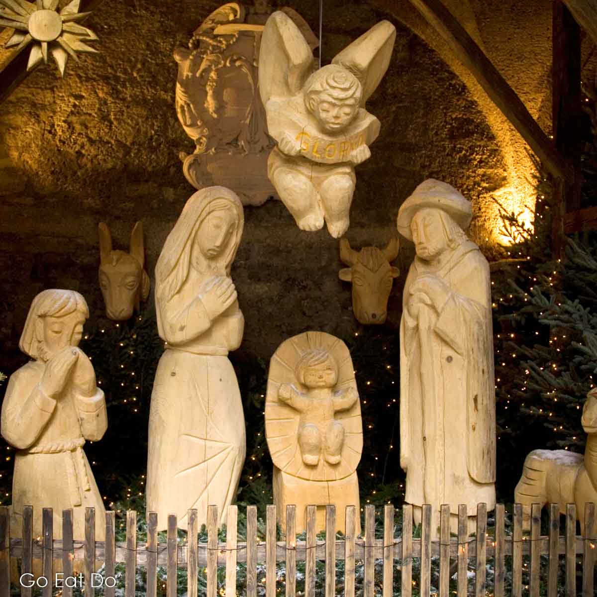 Carved wooden figures in a crib at a Sallzburg Christmas market.