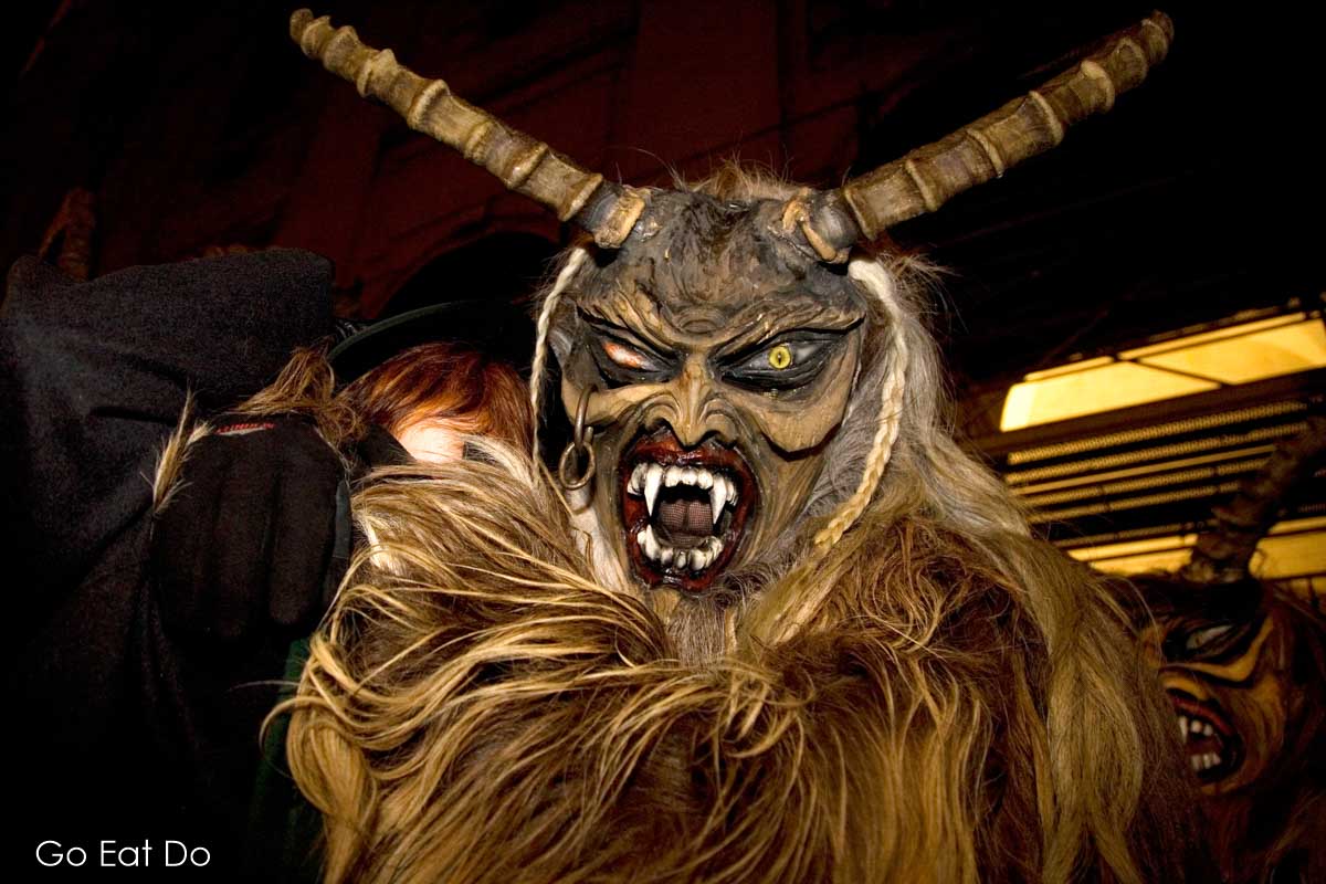 Horned figures at a traditional Krampus run in Austria. The horned Krampus accompanies St Nicholas.