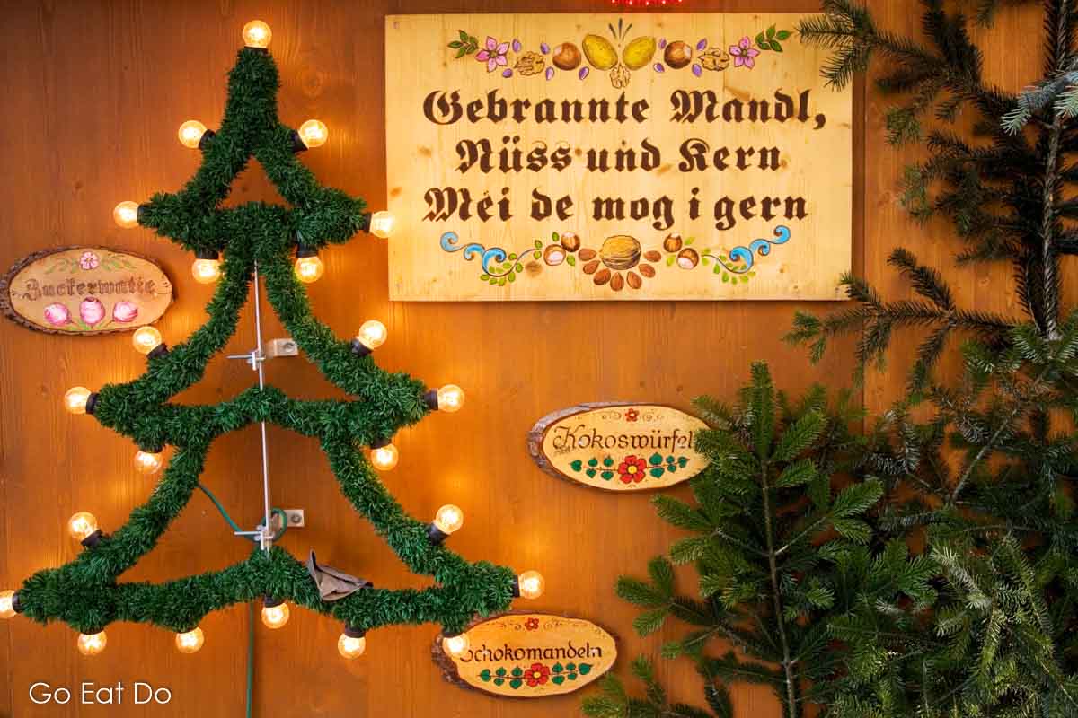 "Roasted almonds, nuts and star, I like them a lot," says a sign in the Bavarian dialect at a Christkindlmarkt in Munich, Germany. 