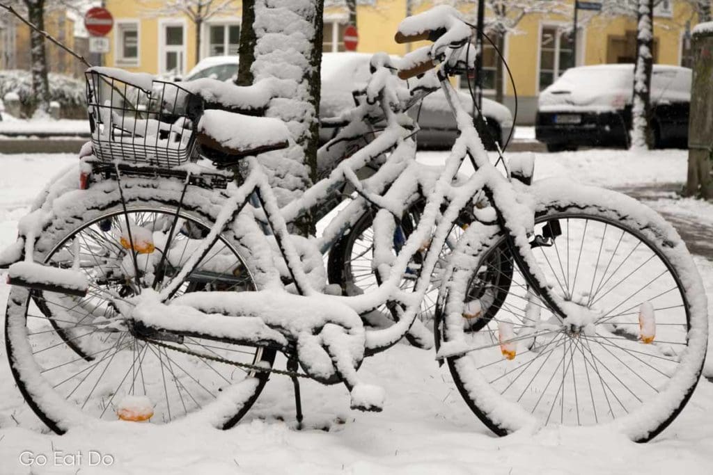 Snow covered bicycles on a December day in Munich, Germany.