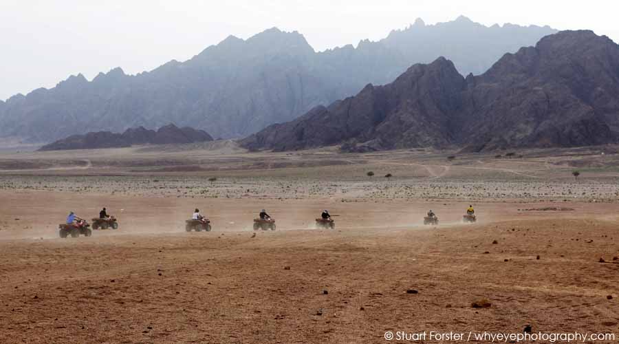 Quad bikers kick up dust riding in the Sinai Desert, close to the Sharm el Sheikh holiday resort in Egypt