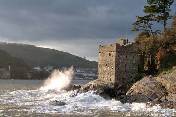 Waves crash on rocks next to Kingswear Castle, near Dartmouth, a property managed by the Landmark Trust
