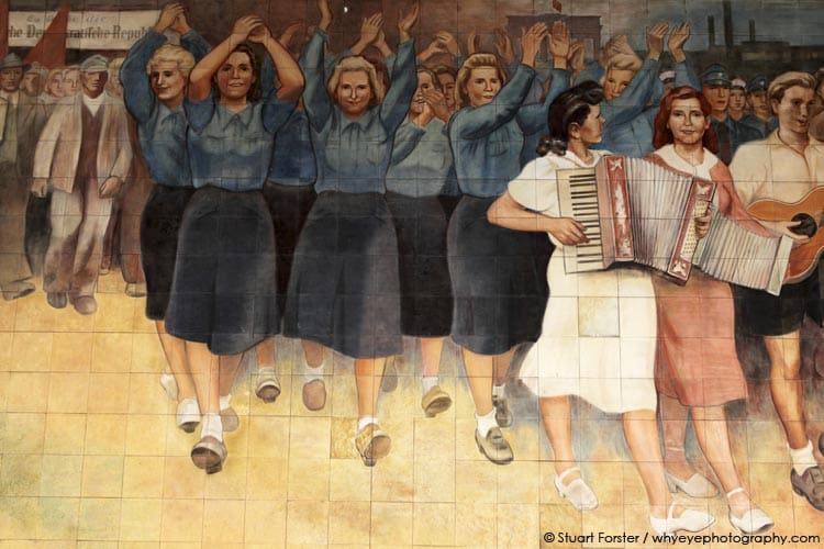 Depictions of East German women in blue FDJ uniforms and playing music on a 1950s mural by Wolfgang Ruppel 'the importance of peace for the cultural development of humanity and the necessity of struggle to achieve this goal' in Berlin, Germany