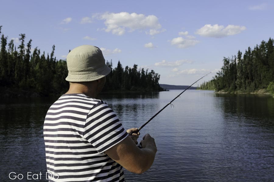 A man fishing for walleye and northern pike at Otter Lake near Missinipe, Saskatchewan, Canada