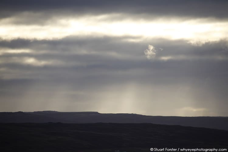 Clouds and sunlight help form a dramatic landscape in Iceland