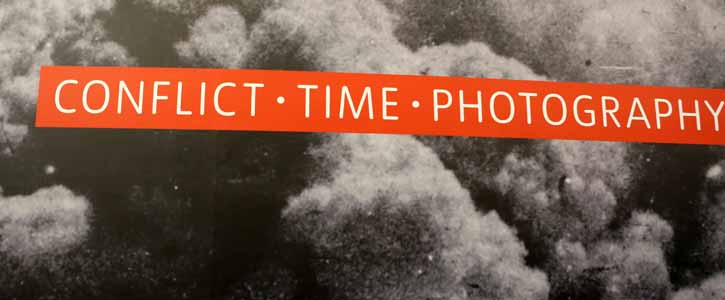 Sign for the 'Conflict, Time, Photography' exhibition at the Tate Modern art museum in London, England