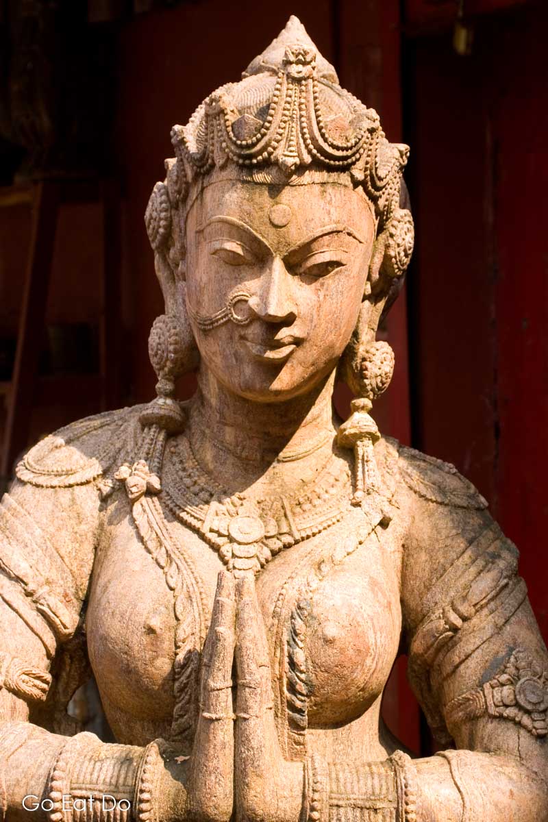 Sculpted figure of a Hindu goddess outside of an antiques store in Fort Cochin, India.