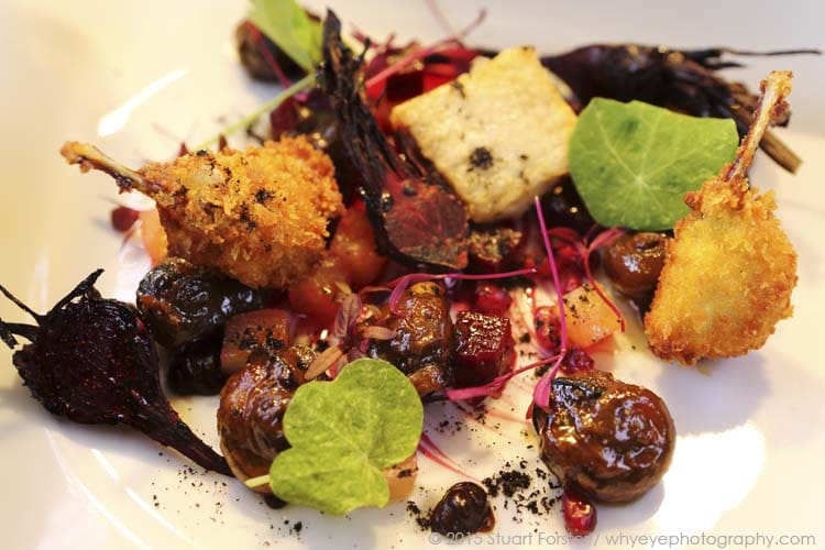 Pan-fried Aylesbury farm snails, Dorset black garlic, grilled baby beetroots, confit chicken wings and fried frogs legs, served at Angelus