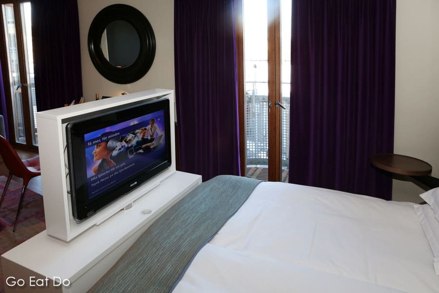 Television screen at the foot of a bed in the designer Berns Hotel in Stockholm, Sweden