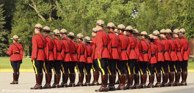 Royal Canadian Mounted Police Officers in red serge at the Sunset Retreat Ceremony at the RCMP Depot in Regina, Saskatchewan, Canada