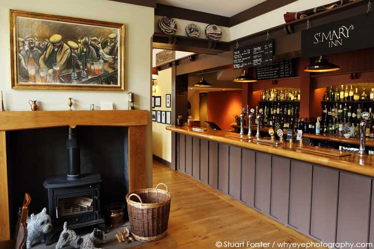 Bar and fireplace at St Mary's Inn, a country pub with bedrooms for bed and breakfast stays near Morpeth in Northumberland