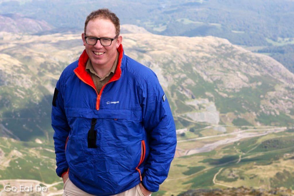 Stuart Forster wearing a blue Snugpak Softie Mountain Leader's Smock on the Old Man of Coniston in the English Lake District