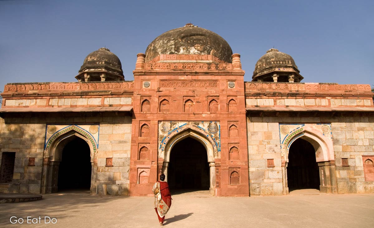 A woman walking towards the Nila Burj, also known as the Nila Gumbad, in Humayan's Tomb Complex.