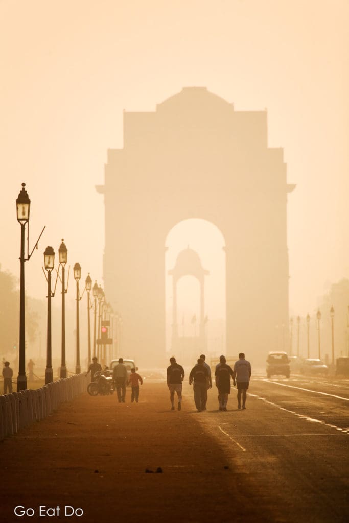 Men walking along the Rajpath towards India Gate in New Delhi.