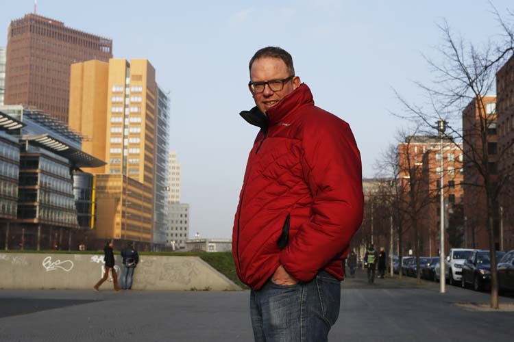 Travel writer and blogger Stuart Forster wears a red Snugpak SJ6 Jacket in Berlin, Germany