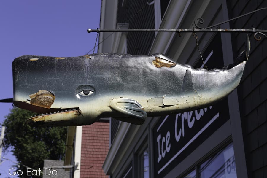 Whale sign hangs outside of a store at Mahone Bay in Nova Scotia, Canada