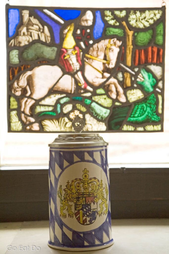 Beer stein and depiction of medieval jousting.