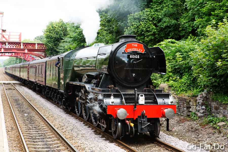 The Waverley steam locomotive pulls the Flying Scotsman through Wylam's railway station.