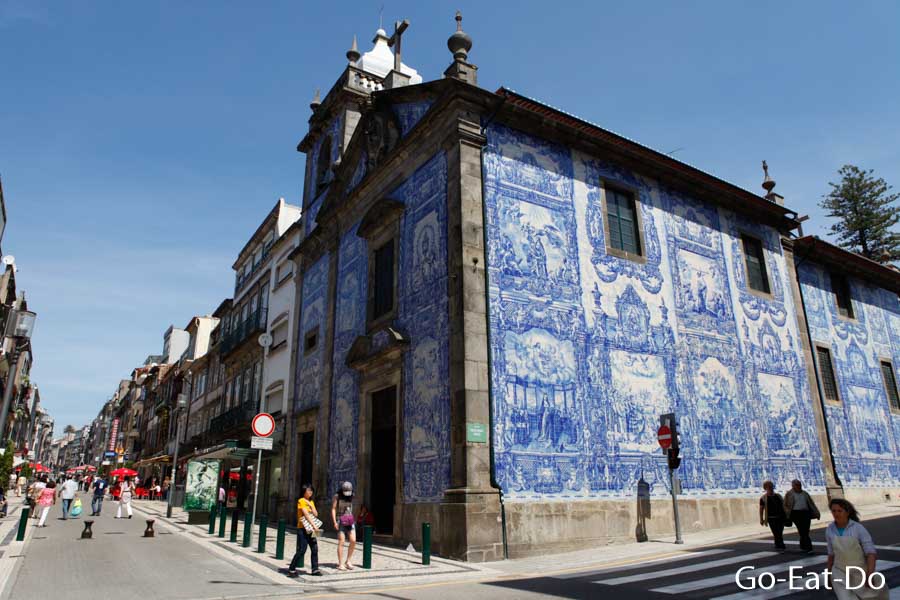 Azulejo tile clad facade of the Capela Das Almas chapel on a sunny day in Porto, Portugal