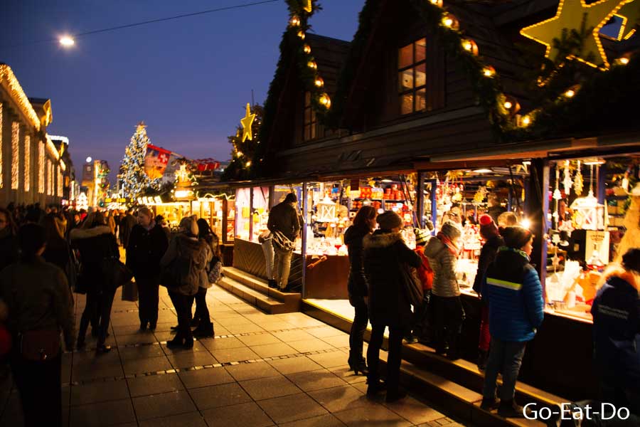 People visit stalls at the Christmas market in Stuttgart, Germany
