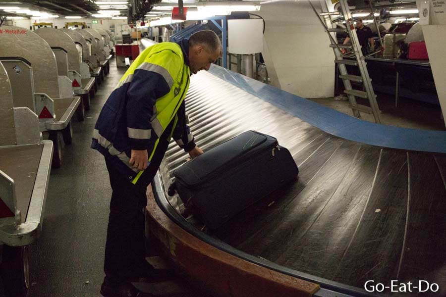 Man in the baggage handling and sorting area at Stuttgart Airport in Stuttgart, Germany