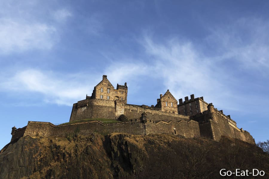 Edinburgh Castle and Castle Rock under a blue sky on a sunny day in Edinburgh, Scotland