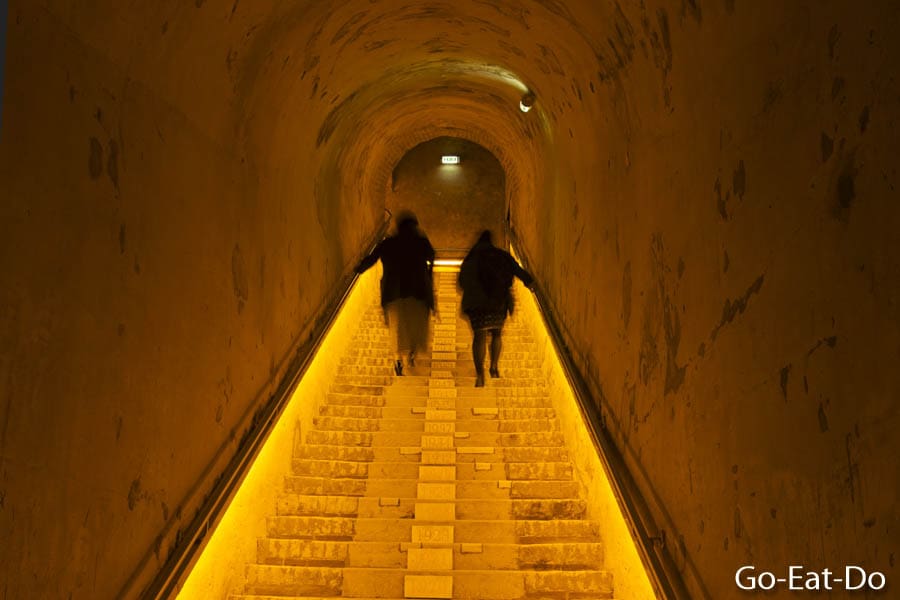 Visitors walk up the staircase of the Veuve Clicquot Champagne cellar in Reims, France