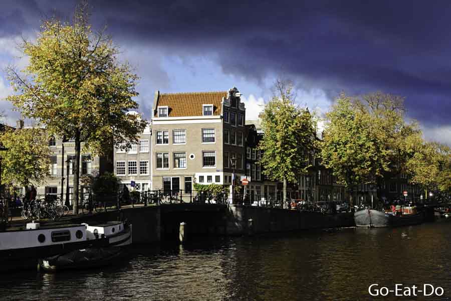 Storm clouds gather over a canal on De Negen Straatjes (Nine Streets) in Amsterdam, the Netherlands