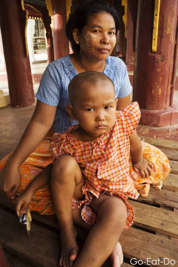 Burmese mother and scowling child in Mandalay, Myanmar