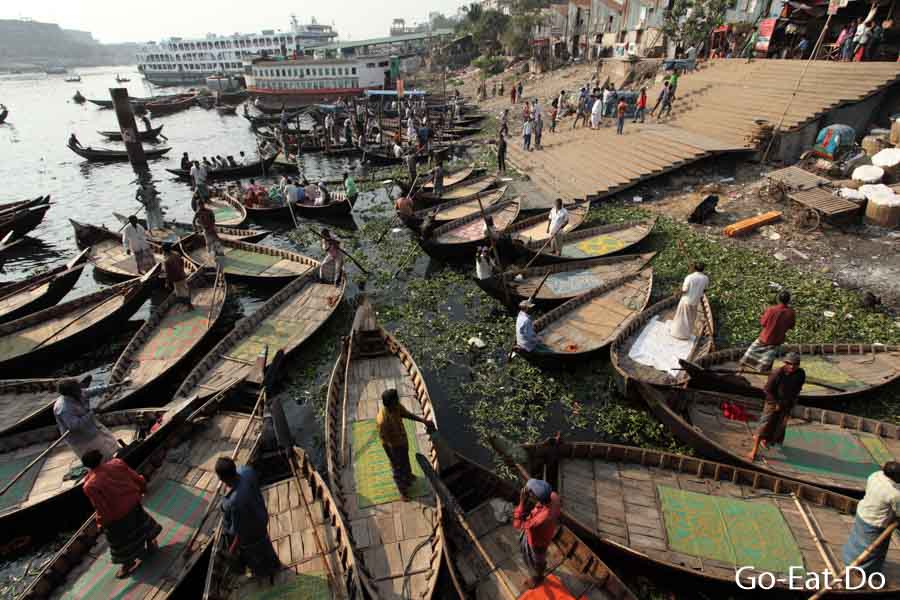 Ferry boats on the Buriganga River by a landing stage next to Sadarghat Boat Terminal in Dhaka, Bangladesh