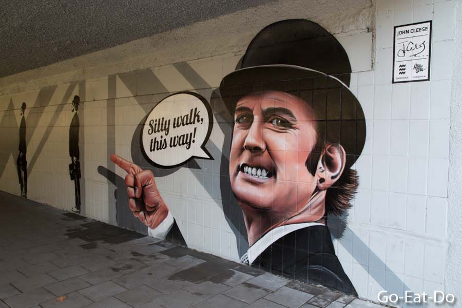 Street art depicting John Cleese wearing a bowler hat, a homage to Monty Python's Flying Circus silly walks sketch, at the Silly Walk Eindhoven in the Netherlands