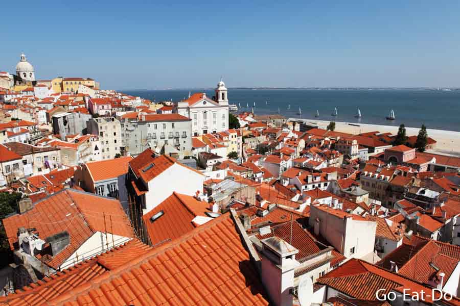 Terracotta rooftops on a sunny day in the Alfama district of Lisbon, Portugal