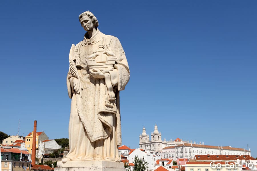 Statue of St. Vincent, patron saint of Lisbon, holding a ship in the Alfama district of Lisbon, Portugal