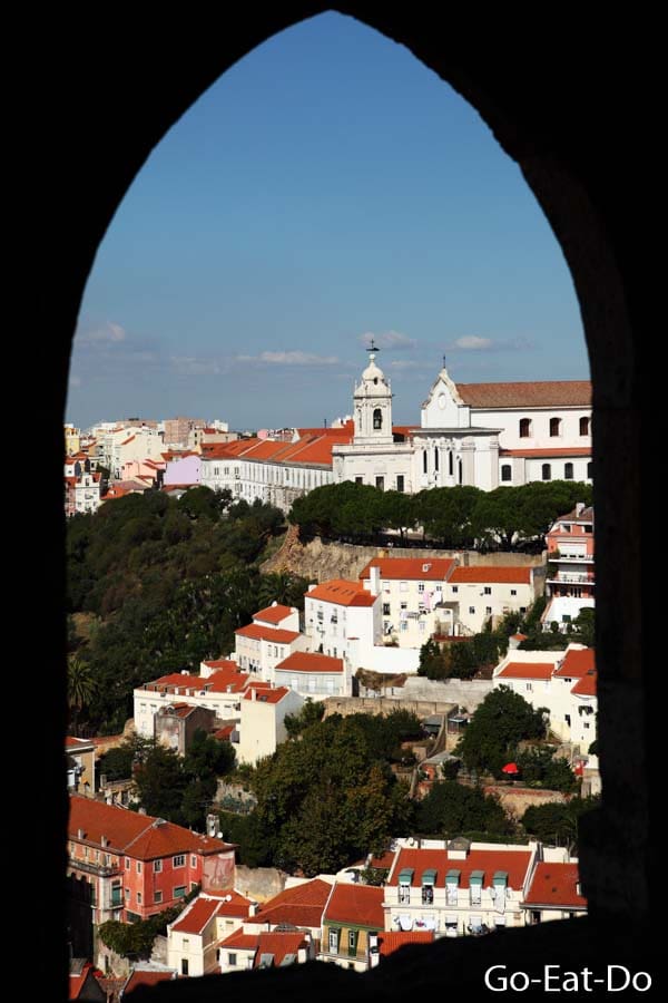 View of the Miradouro da Graça from an arched window at Castle of St George (Castelo de São Jorge) in Lisbon, Portugal.