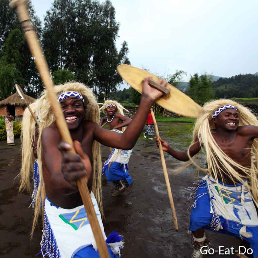Warriors dancing with shields and spears at Iby'lwacu Cultural Village in Rwanda