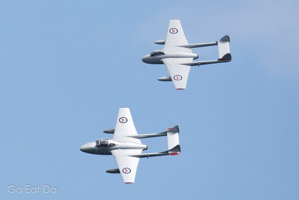 Two de Havilland Vampire jet fighter planes in the livery of the Norwegian Air Force.