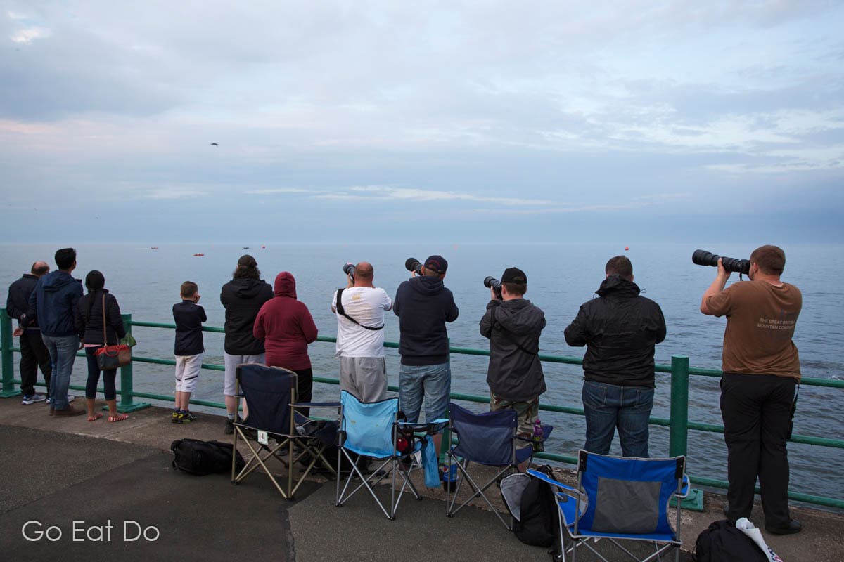 Photographers photographing aircraft at Sunderland International Airshow using long tele-zoom lenses.
