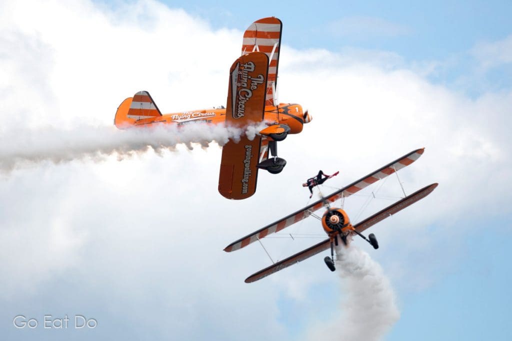 Biplanes flying during a wing walking display at Sunderland International Airshow in North East England.