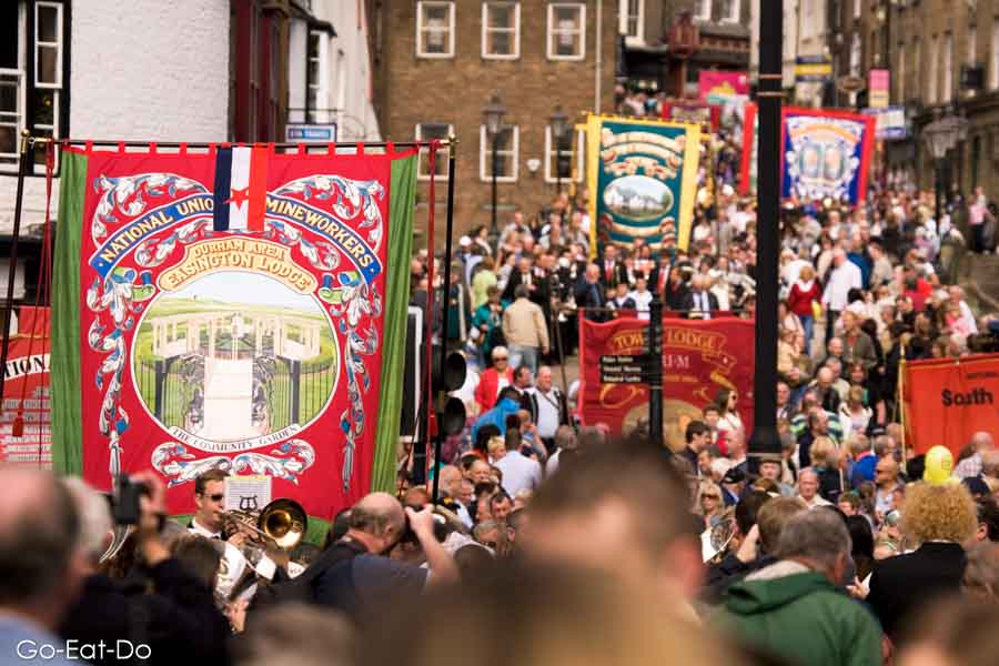 Union banners and crowds of attendees on Old Elvet in Durham City during the Durham Miners' Gala, also known as 'the big meeting'