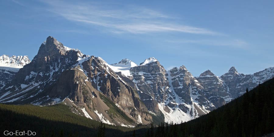 Snow-capped mountains under a blue sky in the Canadian Rockies at Banff National Park, Alberta, Canada
