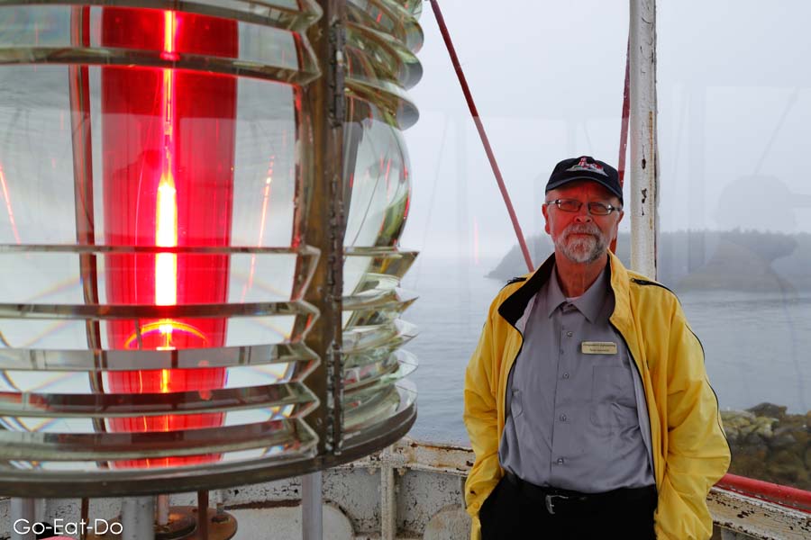Guide Peter by the light at Head Harbour Lightstation, a lighthouse on Campobello Island in New Brunswick, Canada