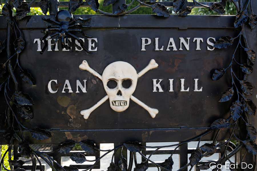 Skull and crossbones sign warns of the potential danger caused by plants within the Poison Garden at The Alnwick Garden, Northumberland