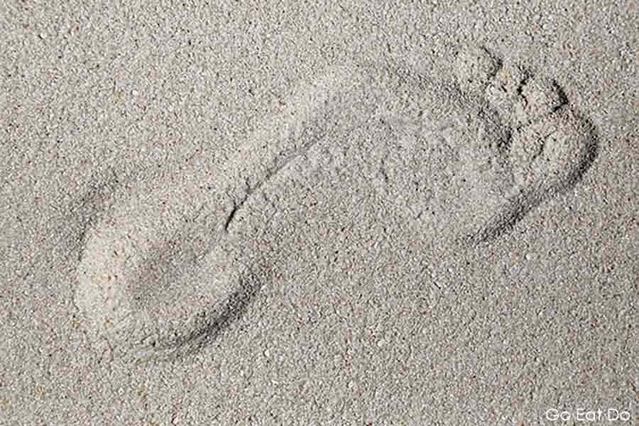 Footprint on sand on a beach in the Maldives