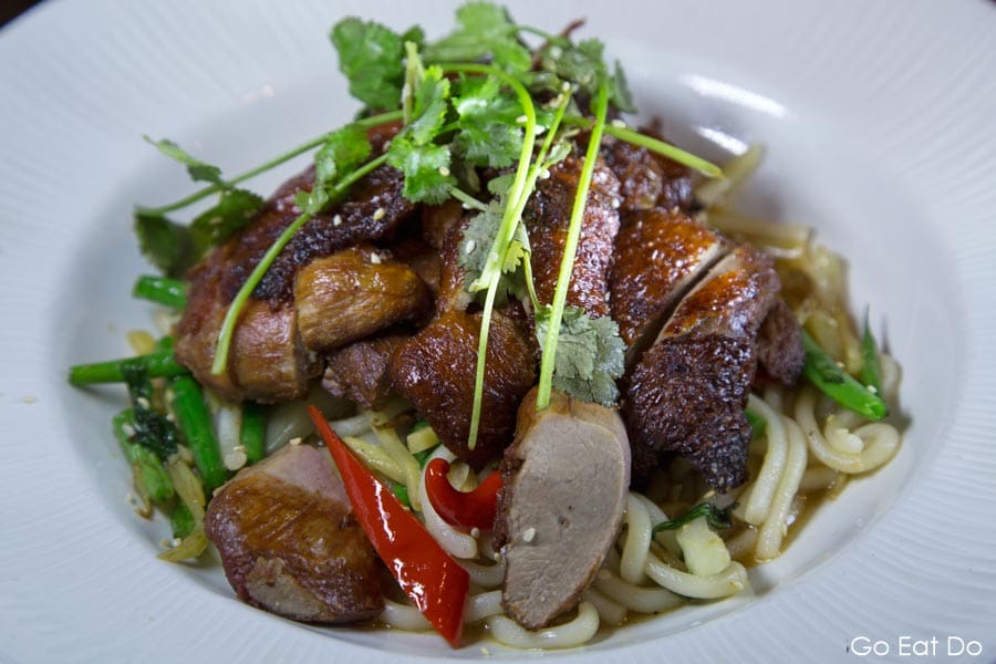 Crispy skinned duck breast served with udon noodles and coriander served at Ramside Hall's Fusion restaurant in Durham, England